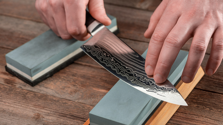 sharpening knife on whetstone