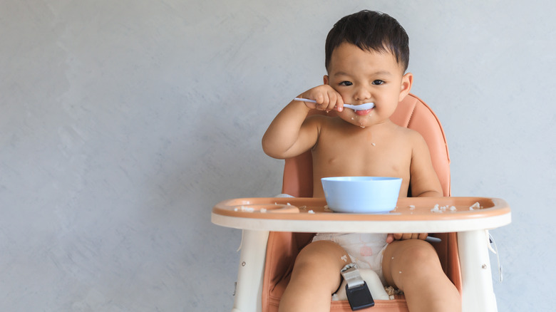 Baby eating in high chair