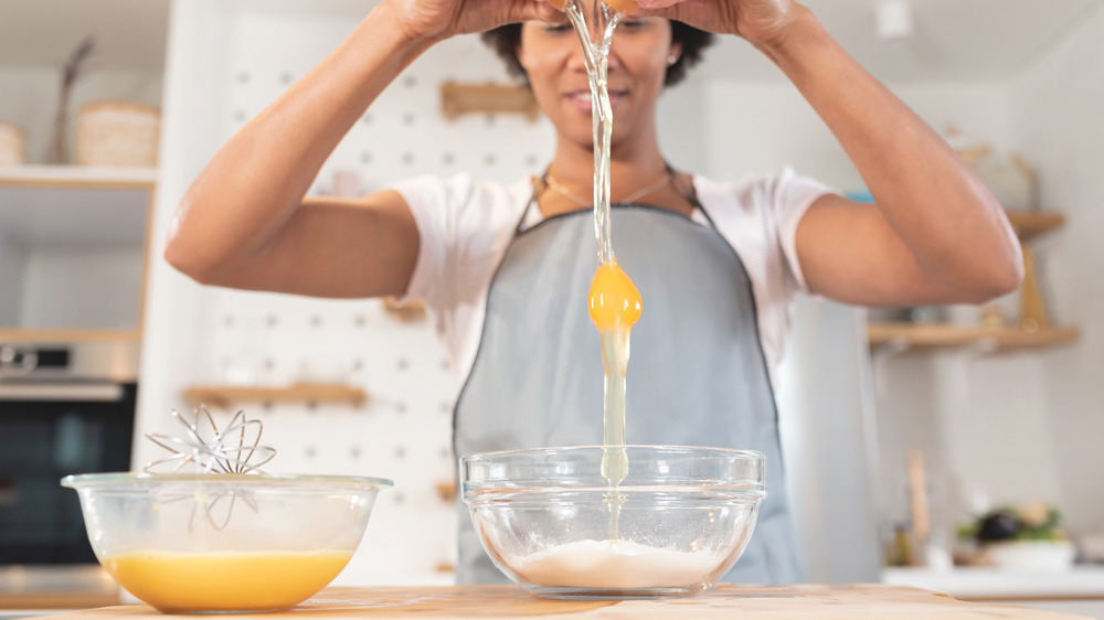 Woman cracking egg into bowl