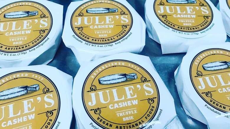 Rows of Jule's Foods Cashew Truffle Brie cheeses