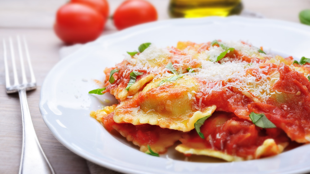 close up of plate of ravioli with tomato sauce