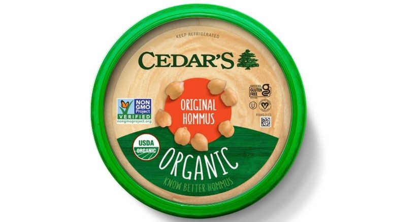 A green tub of Cedar's hummus