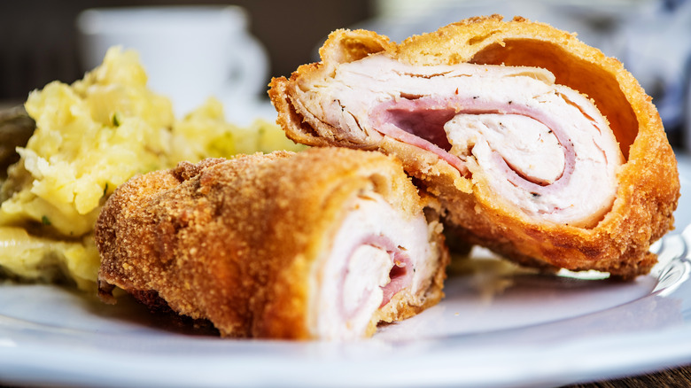 Cooked chicken cordon bleu on plate