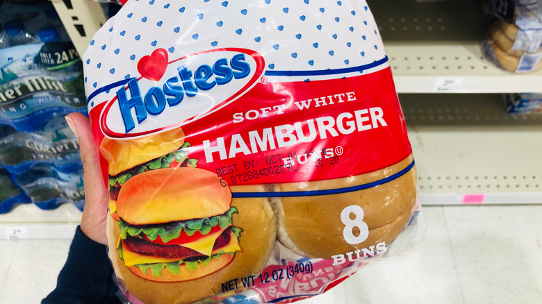 Person holding Hostess hamburger buns