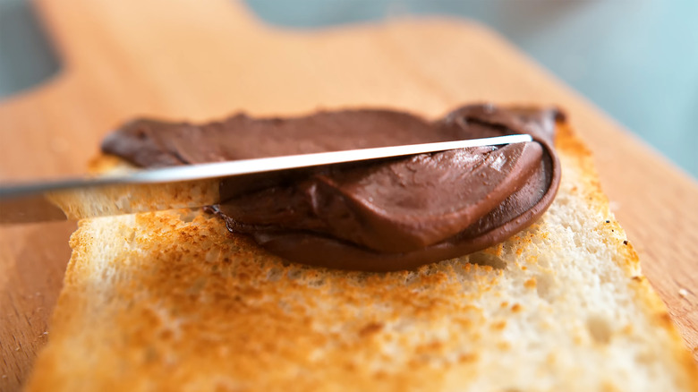 Spreading Nutella on toast