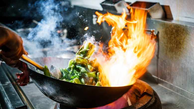 cooking pan of food with big flames