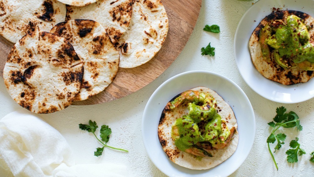 Charred tortillas and tacos on plates