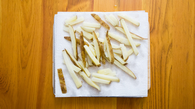 fries draining on paper towels