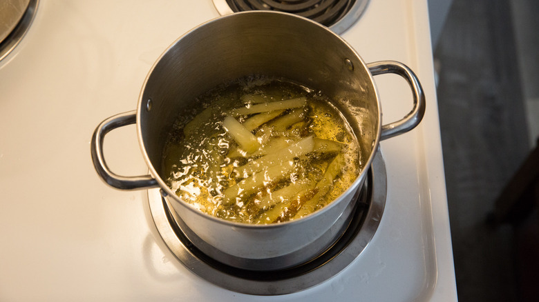 fries frying in medium pot