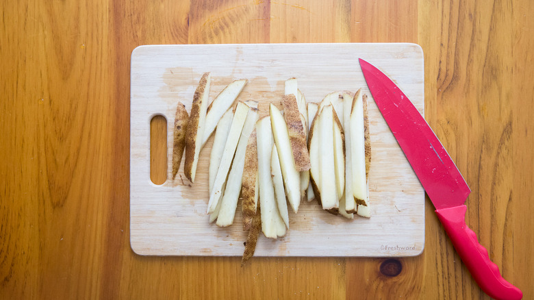 sliced potatoes on cutting board