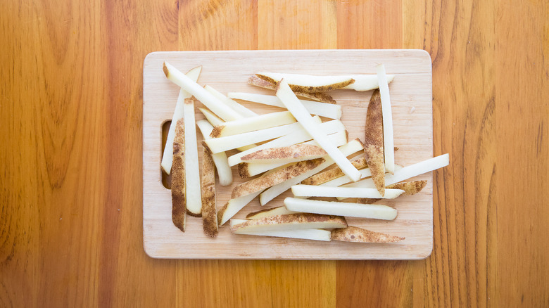 sliced potatoes on cutting board