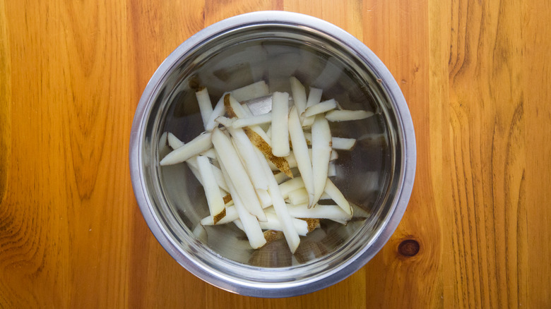potato slices in mixing bowl