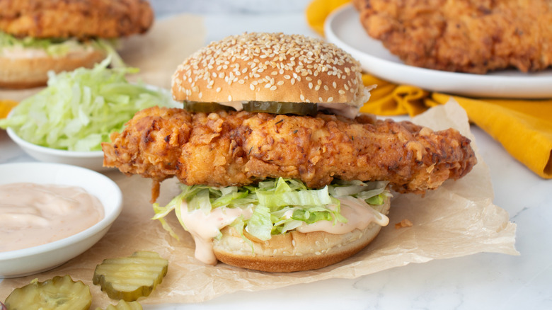 Copycat KFC spicy zinger chicken sandwich surrounded by toppings