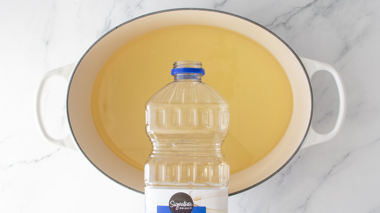 Oil container above pot full of oil