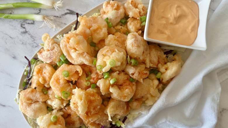 Tempura popcorn shrimp on platter with sauce