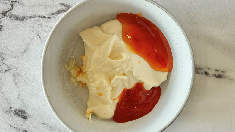 Mayonnaise, garlic, and red sauces in bowl