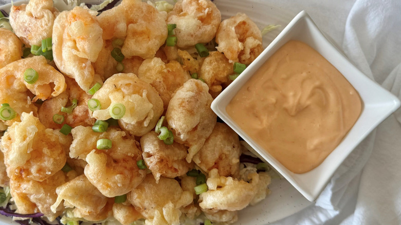 Tempura fried shrimp on platter with dynamite sauce