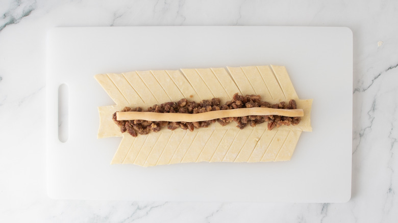 pastry dough topped with brown sugar, nuts, and marzipan