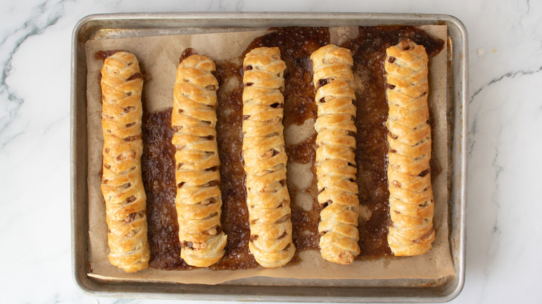 five braided pastry sticks in a pan