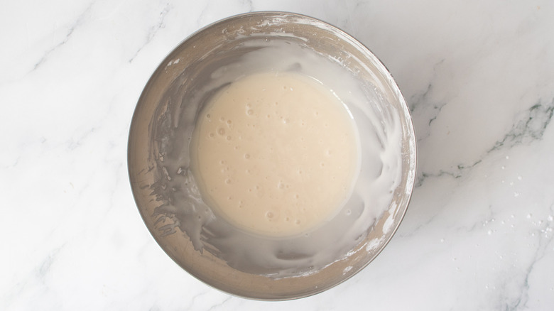 powdered sugar glaze in a metal bowl