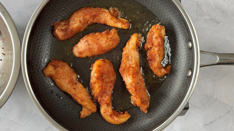 chicken strips in a frying pan