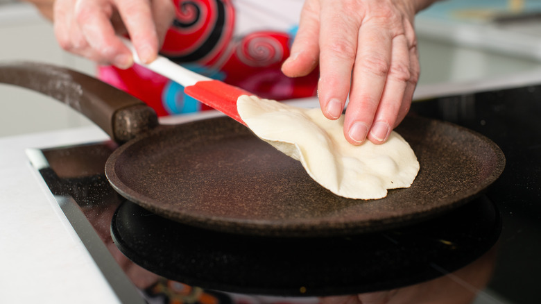 Person cooking a tortilla