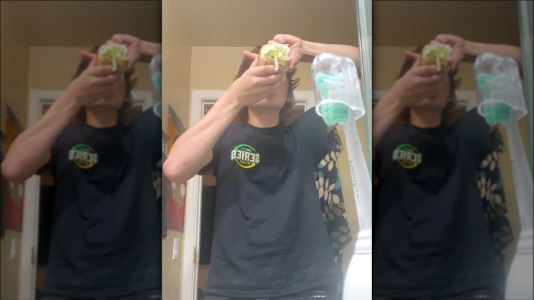 guy taking a hit from his Subway sandwich bong