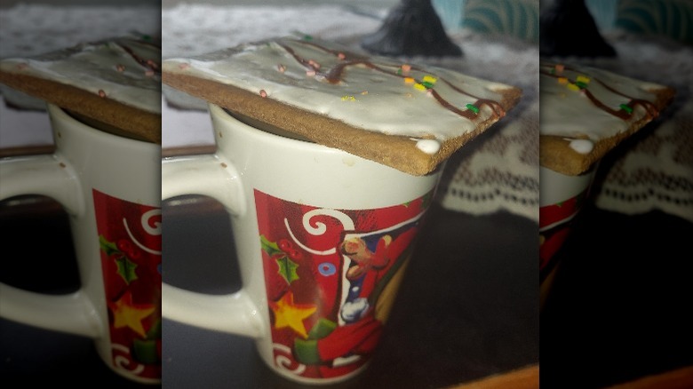 pop-tart on mug full of coffee, frosting side up