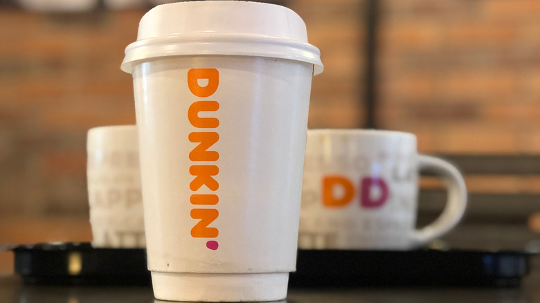 Dunkin' coffee mug and takeout cup