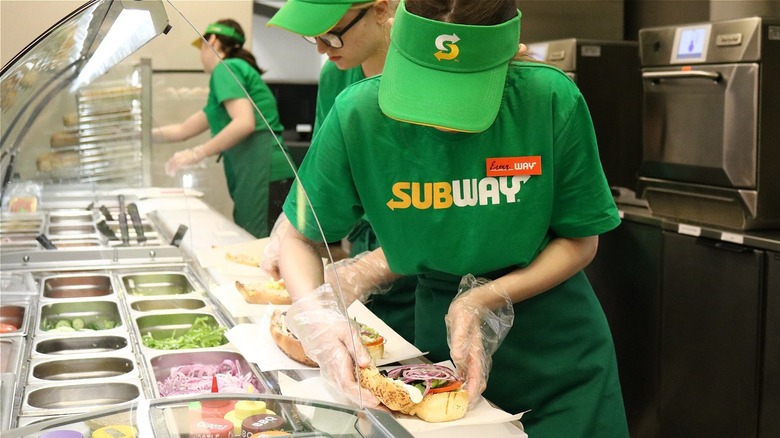 Subway sandwich artist making subs