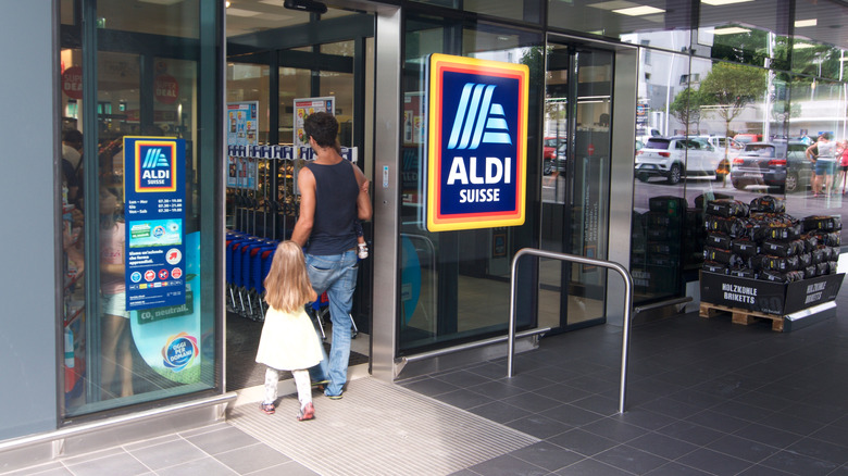 Man and child entering Aldi 