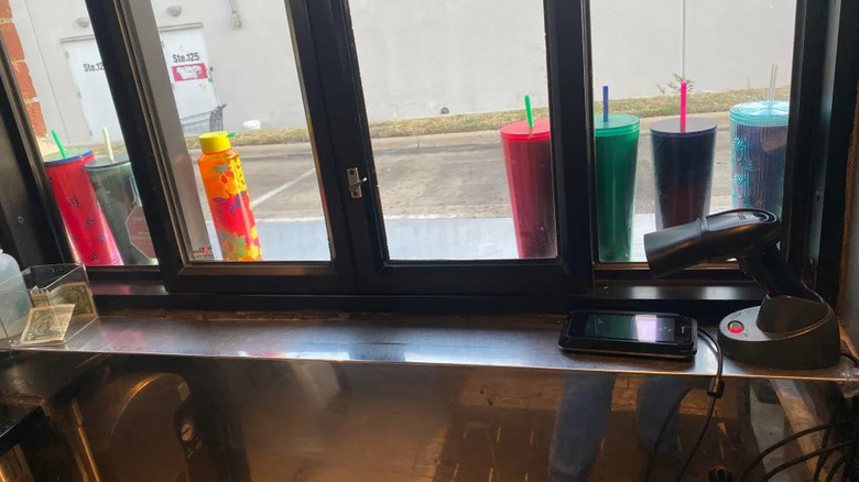 Starbucks cups in drive-thru window 