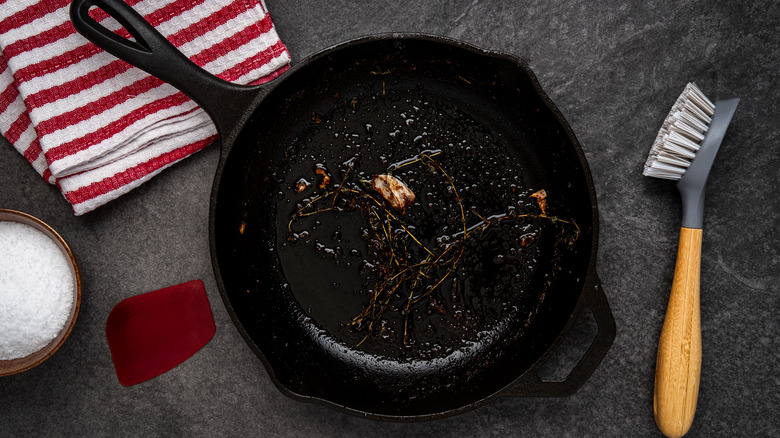 dirty cast iron pan and brush
