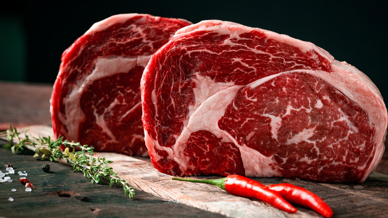 Marbled red steaks on table