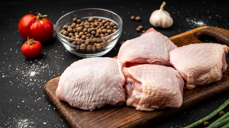 raw chicken thighs on a cutting board