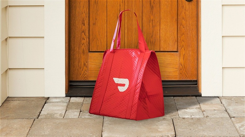 DoorDash bag in front of door