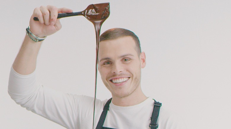 Amaury Guichon holding a spoon of chocolate
