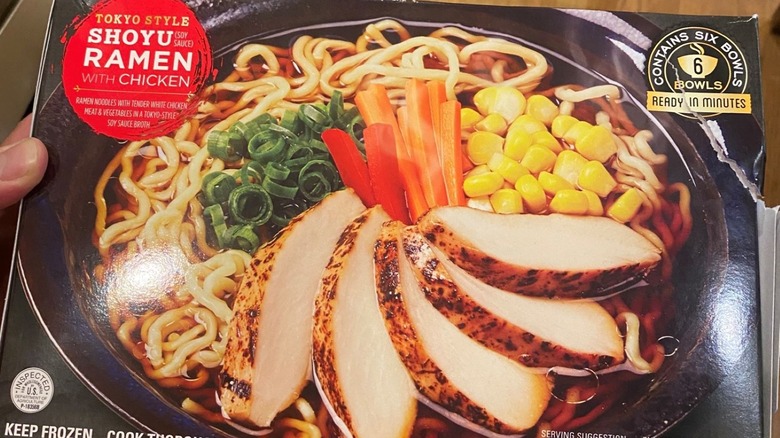 Hand holding the new black ramen package