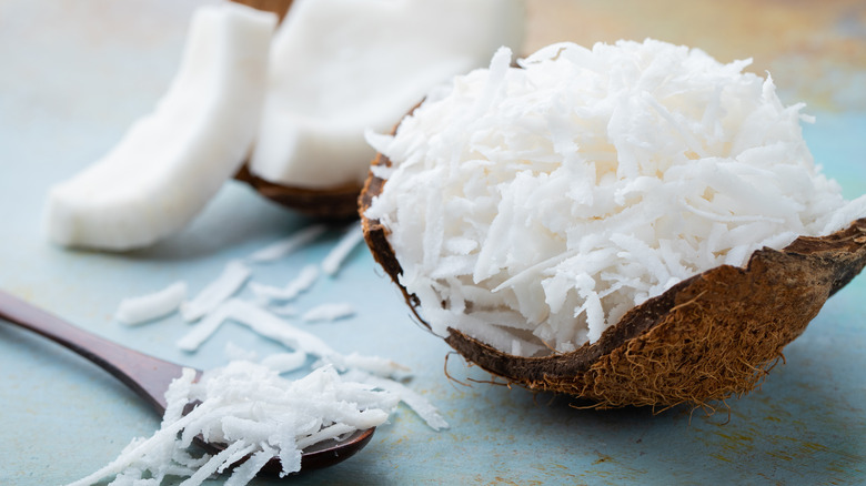 Coconut flakes inside a coconut shell