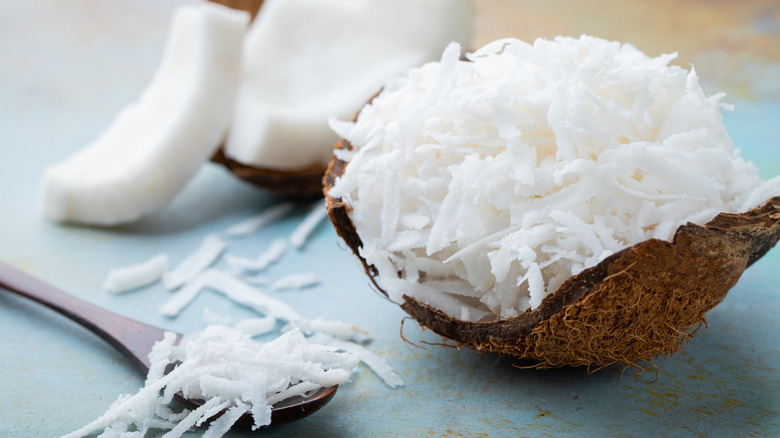 Coconut flakes inside a coconut shell