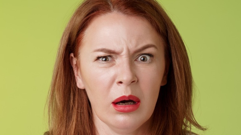 shocked woman making face