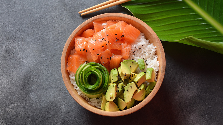 Salmon poke bowl on gray table