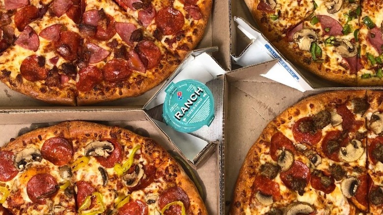 4 Domino's Pizzas with ranch cup in the middle