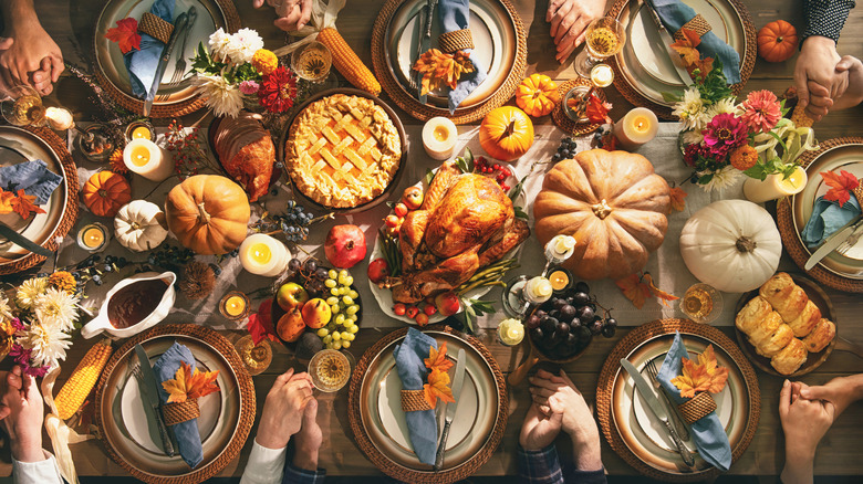 Thanksgiving feast on a table with turkey and pies