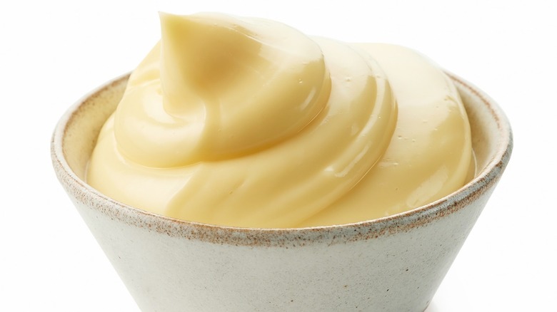 Cup of mayonnaise with white background