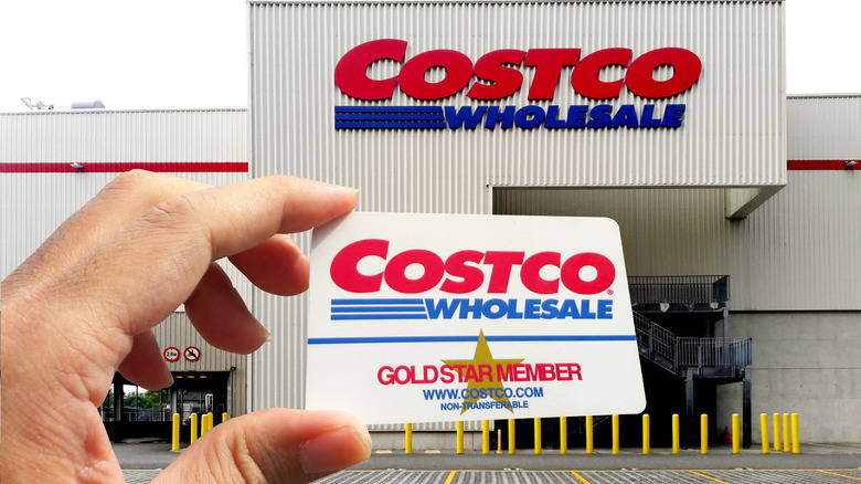 Holding a Costco card in front of the store