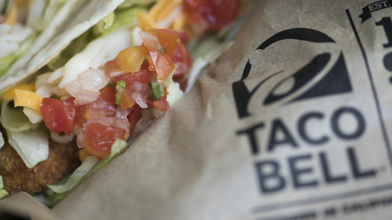 Taco alongside Taco Bell logo on wrapper