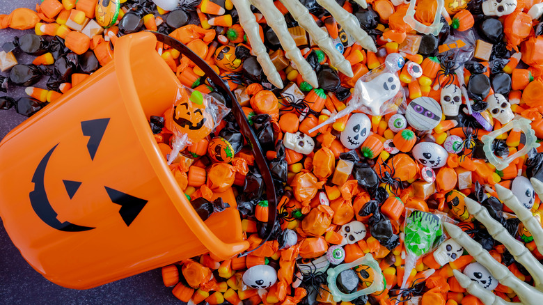 Pumpkin pail spilling Halloween candy