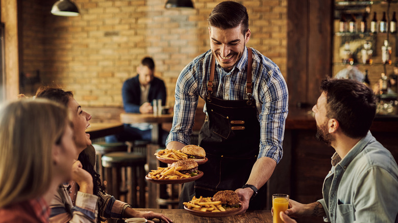 server bringing plated food to table