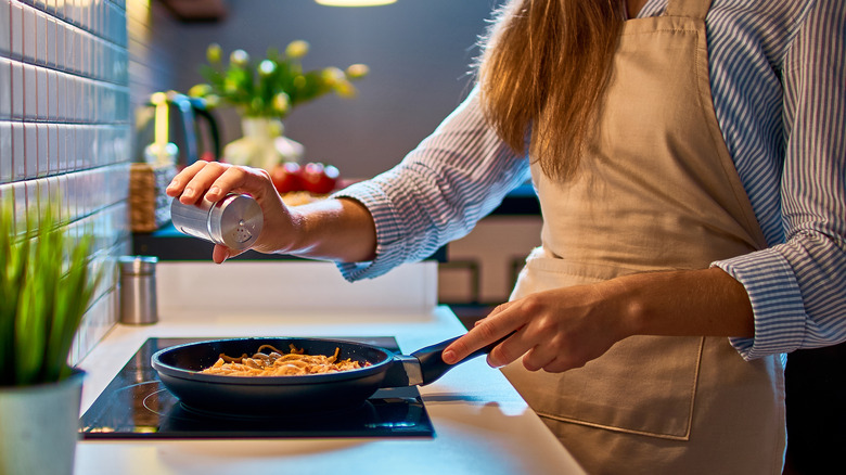 Salting food in the pan 